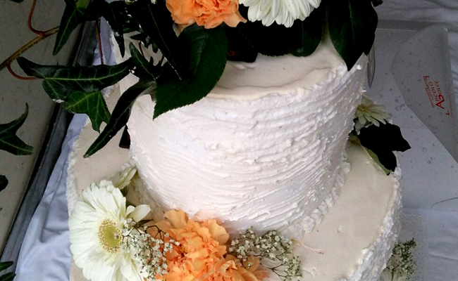 Torta da Matrimonio a piani con decori di panna e fiori freschi